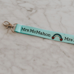 Personalised lanyards with safety break away clip and a lobster claw. Light Blue lanyard with rainbow design. Close up of lobster clip and rainbow design